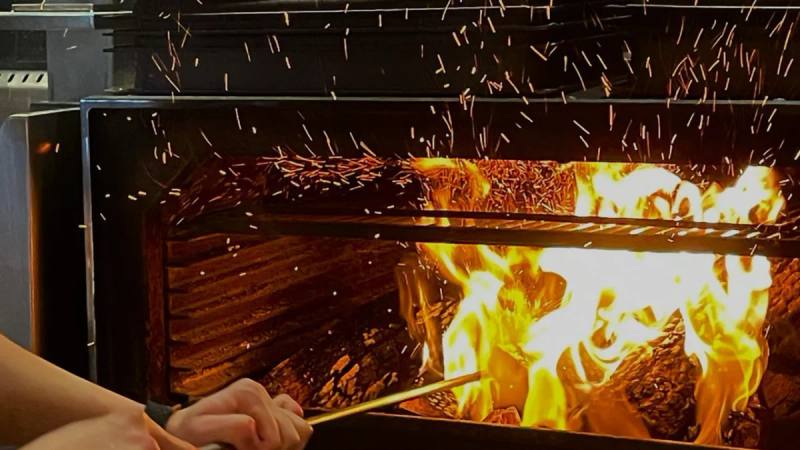 Cooking over the wood fire at Fireplace by Bedrock
