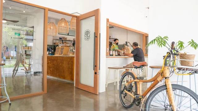 The Social Space Potong Pasir counter and open entrance, with a bicycle in the foreground.